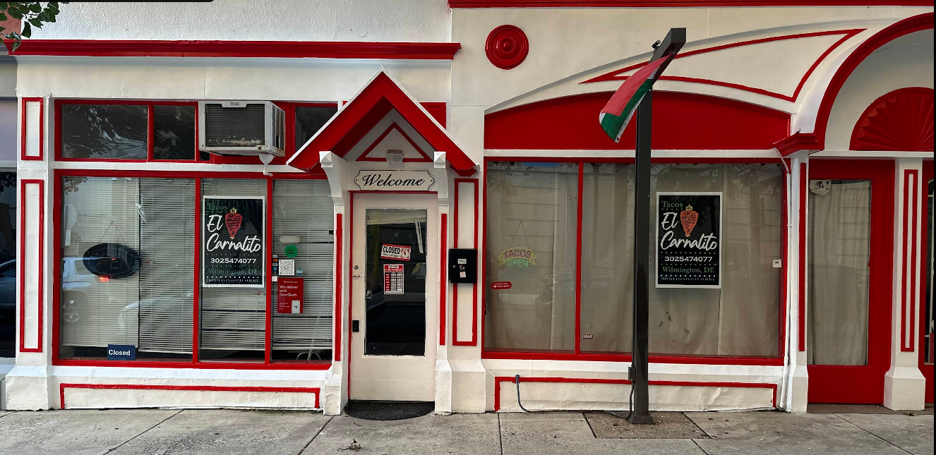 The exterior of Tacos El Carnalito at 304 W 9th St, Wilmington DE — a distinctive white building with bold red trim